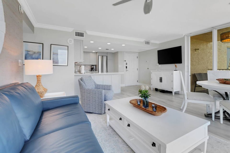 The open, main living area includes living, dining and kitchen - all share a view of the wall mounted TV with community provided DirecTV programming.
