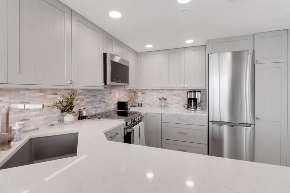 Cookware, dinnerware, kitchen tools and small electrical appliances are provided, including a drip coffee maker.