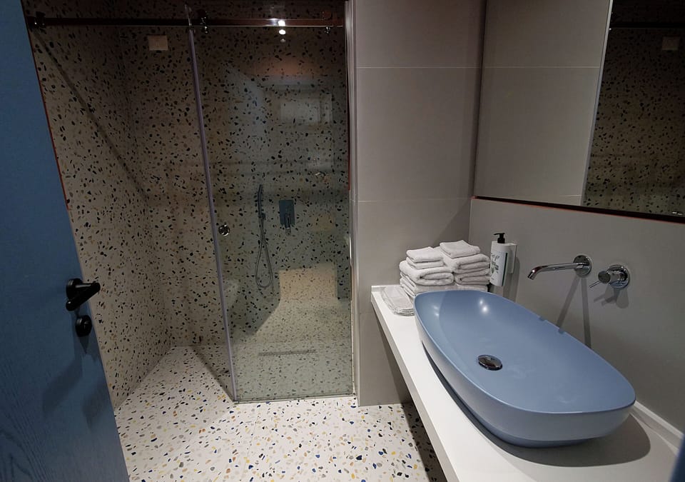 Shower, hair dryer, slippers, towels