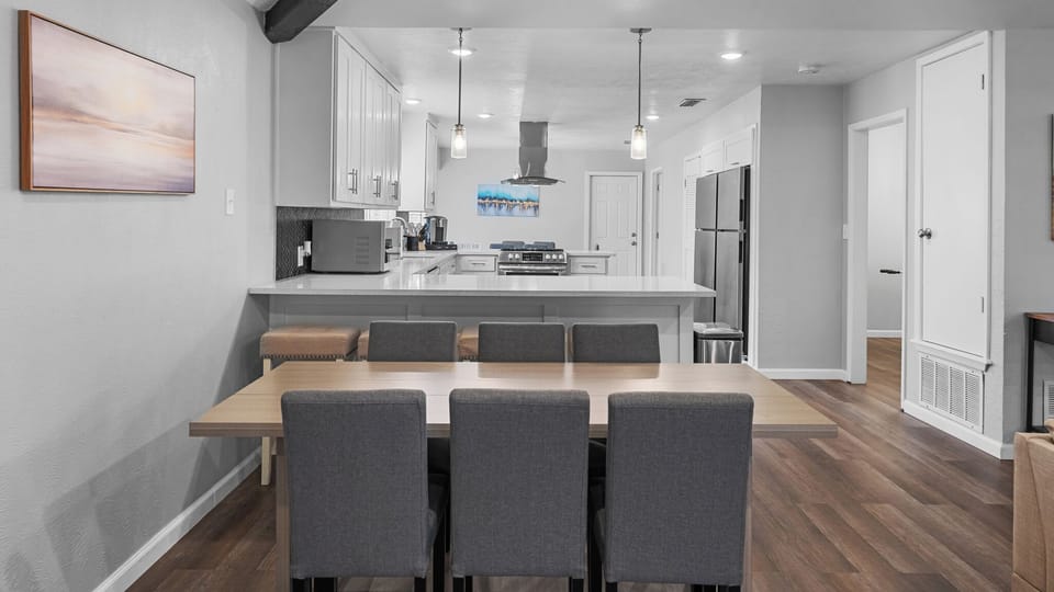 Welcome to a beautifully designed kitchen featuring modern cabinetry and a spacious dining table, perfect for sharing meals and creating memories. Enjoy the sleek countertops and impeccable finishes that make this apartment a true gem.