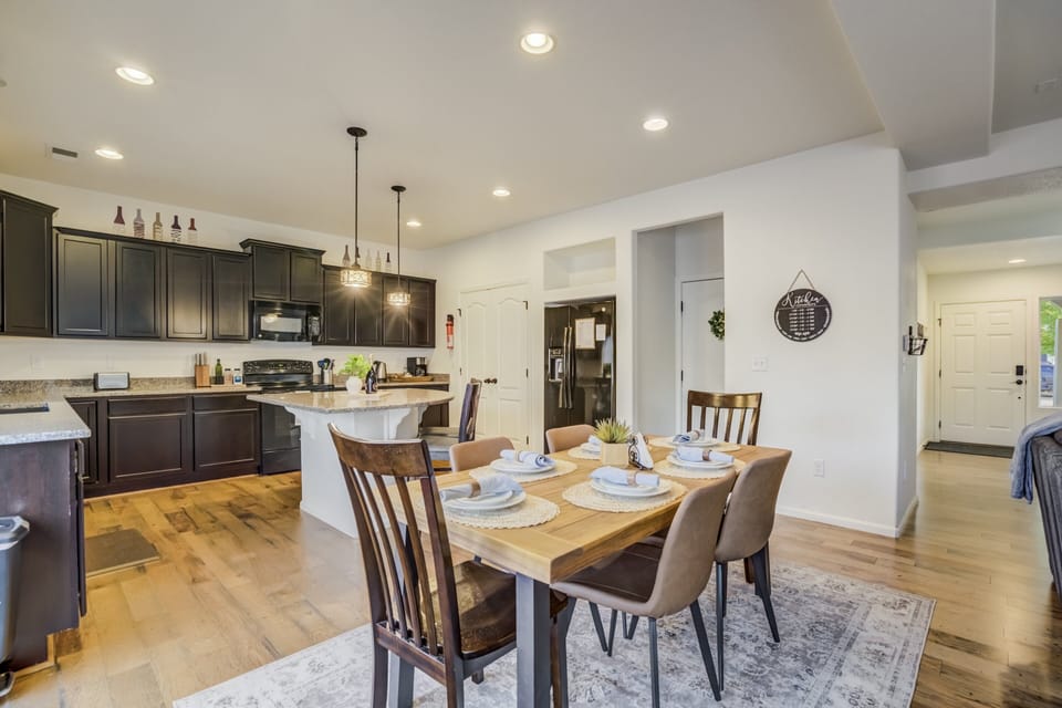 With seating for six at the dining table and additional bar seating at the island.