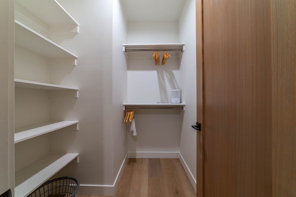 Bedroom 2 closet with shelves and hanging space for clothing storage.