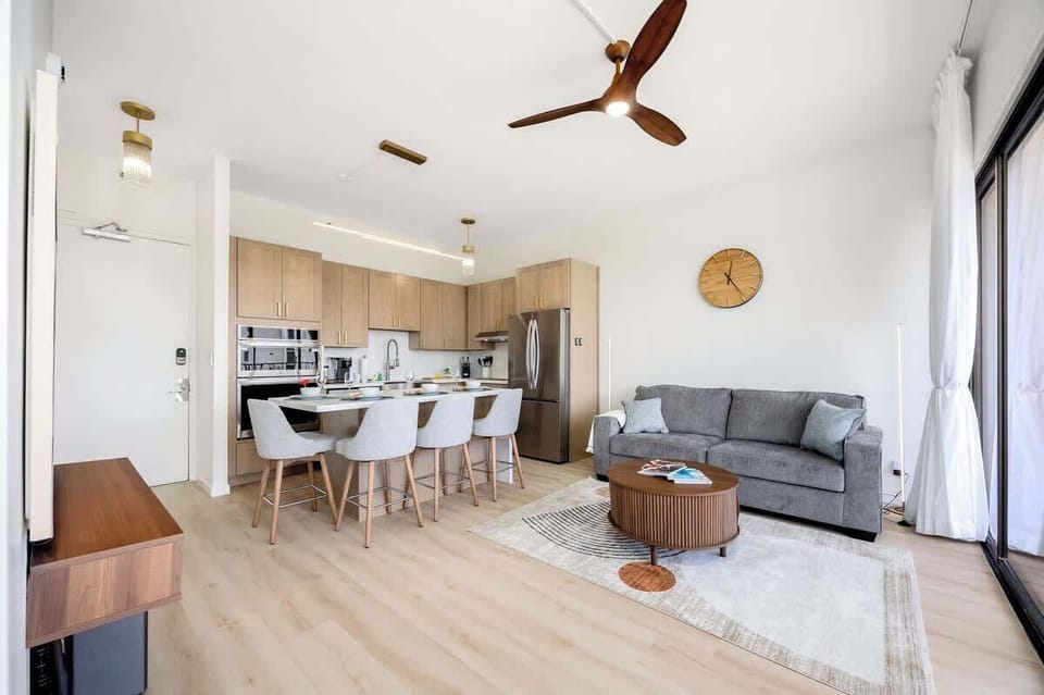 Overview of the living room, dining area, and full kitchen