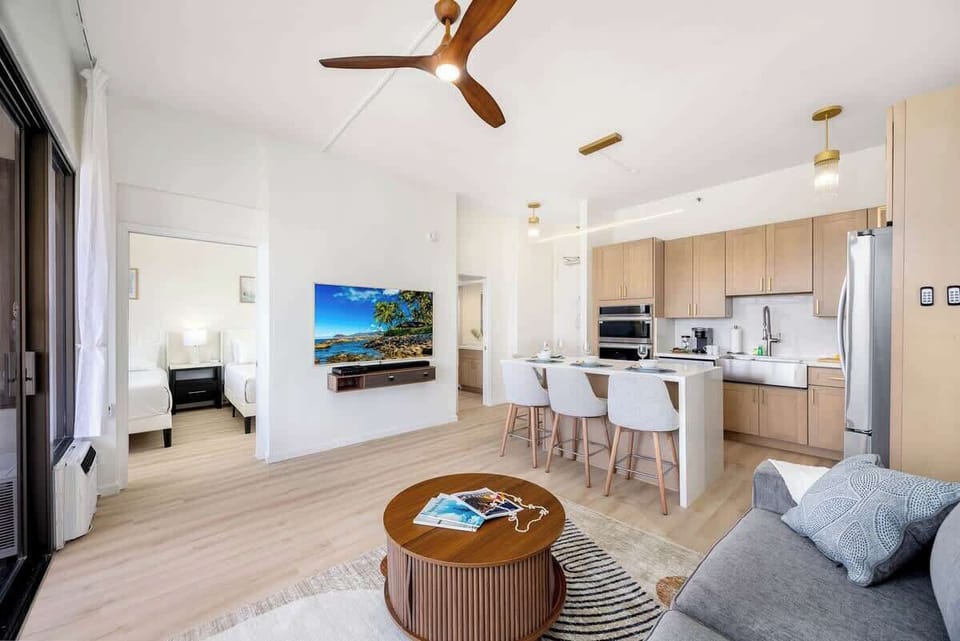 Overview of the living room, dining area, and full kitchen
