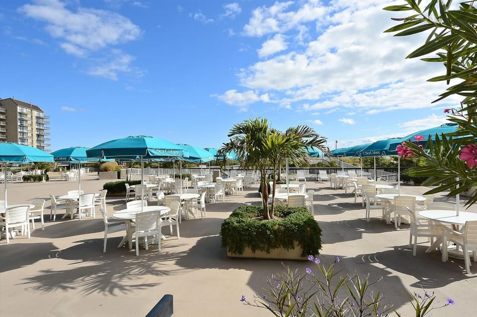 Sea Colony Outdoor Dining Area - Located right on the coast, this outdoor dining area offers umbrella-shaded tables and tropical landscaping. It’s an ideal spot for residents to enjoy a meal while taking in the Atlantic breezes.