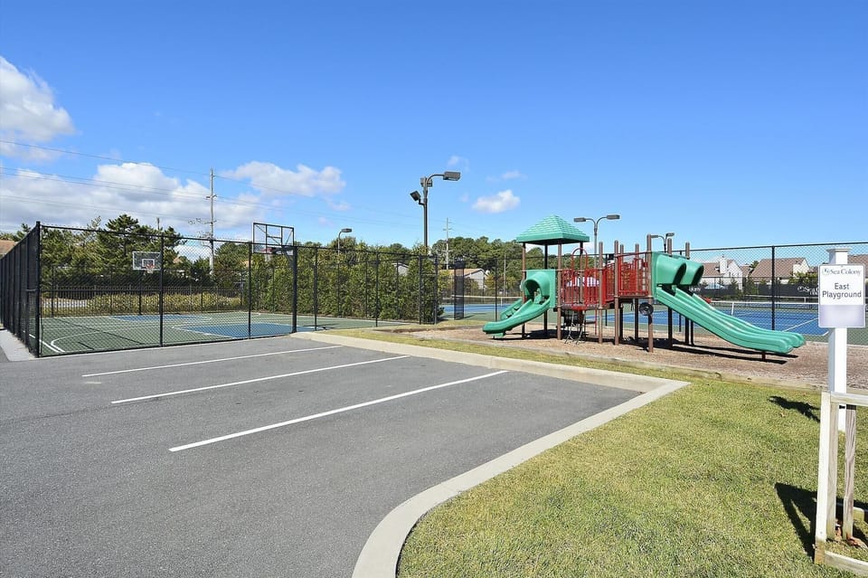 Sea Colony West - Basketball and Playground Complex - This integrated recreation area features a full-sized outdoor basketball court and a modern children's playground. Located conveniently near guest parking, it provides a safe and active space for families to enjoy the outdoors within the resort grounds.