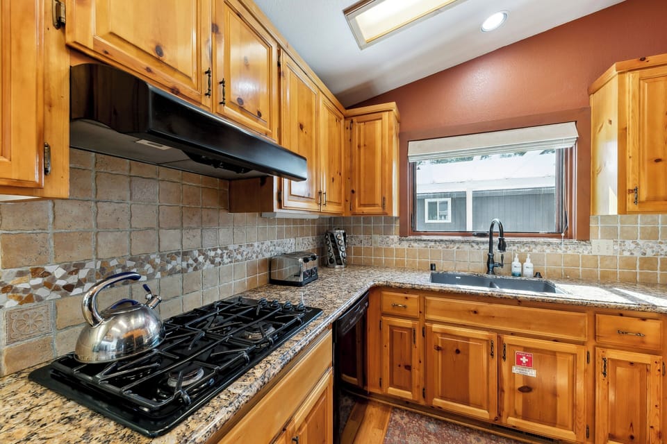 Your fully equipped kitchen features warm wood cabinets, granite counters, and everything you need to create memorable meals during your stay.