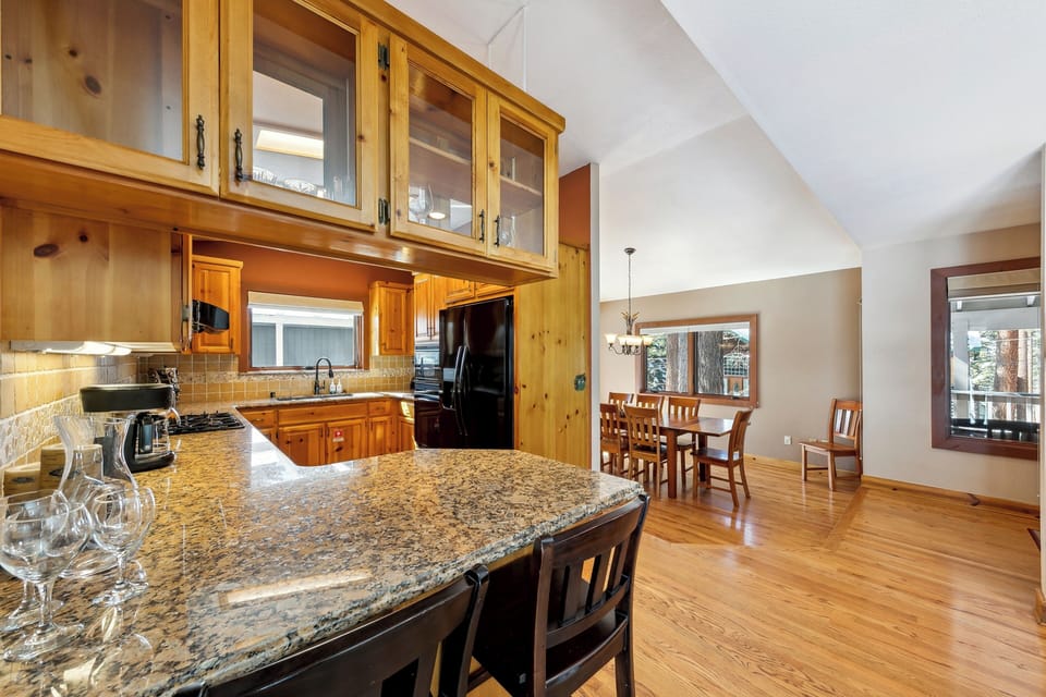 Your fully equipped kitchen features granite countertops, warm wood cabinetry, and an open layout perfect for cooking and entertaining.