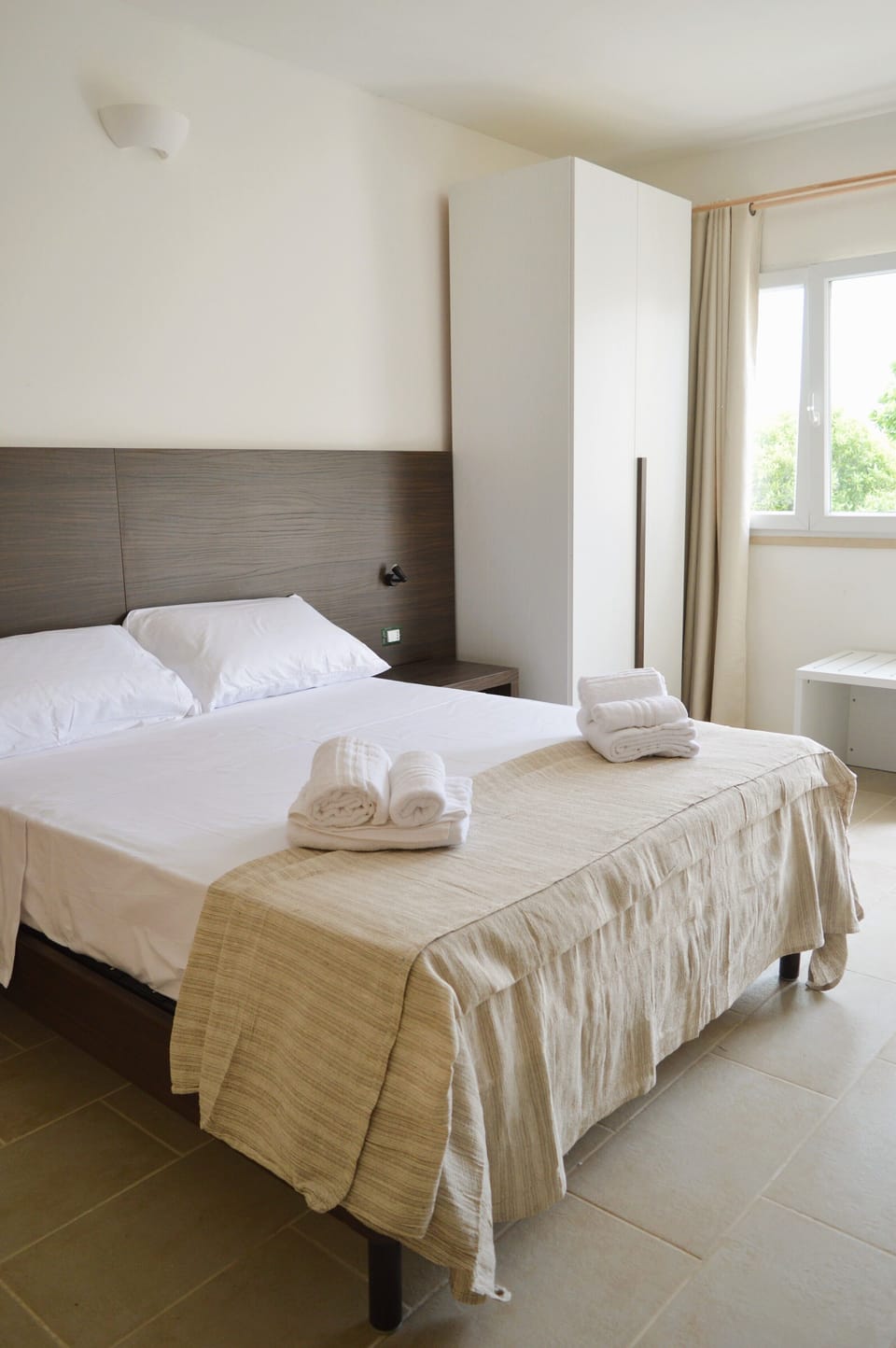 Junior Quadruple Room, Garden View | Minibar, desk, laptop workspace, blackout drapes