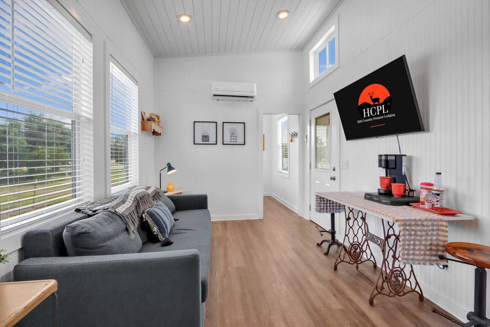 The living room features a TV