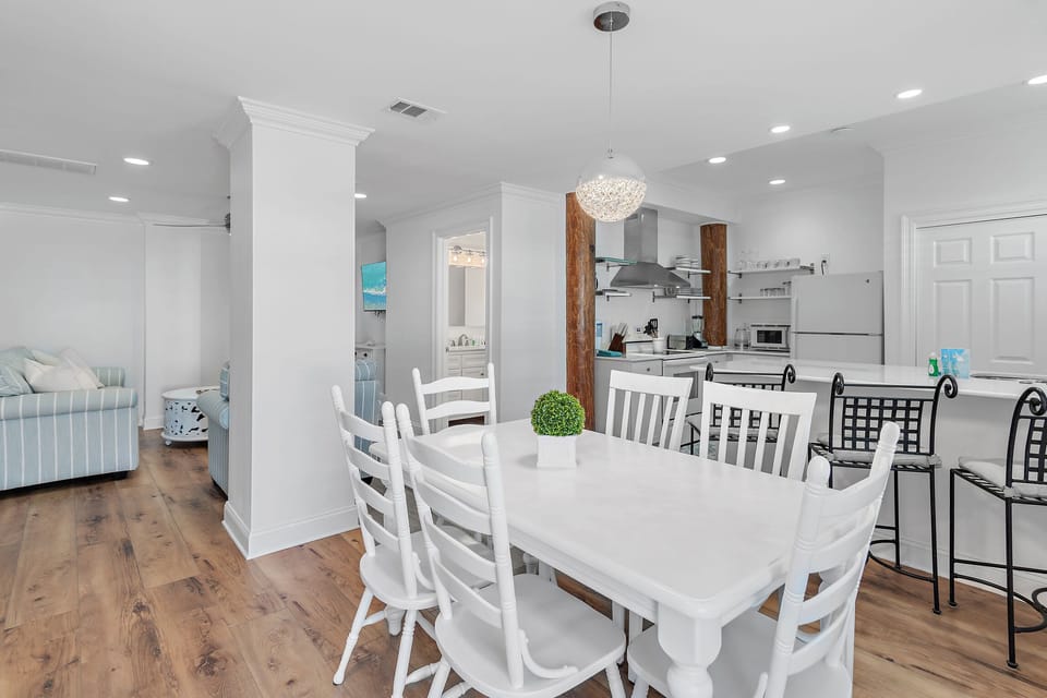 Large, Open Kitchen, Dining, and Living Space with Comfortable Seating around a large Smart TV, Dining Space for 9