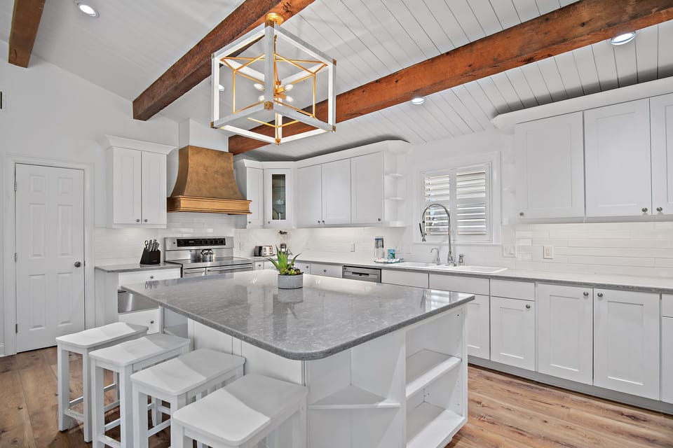 GOURMET, FULLY-STOCKED KITCHEN: Cook in style with upscale appliances, custom cabinetry, and multiple refrigerators in the Fully Remodeled Kitchen