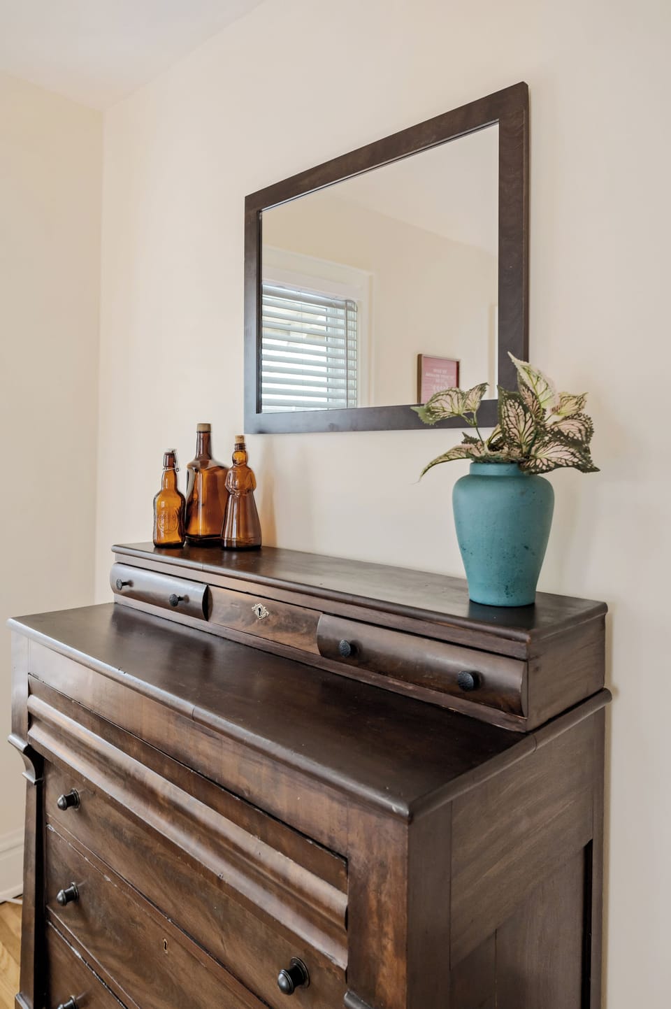 Primary bedroom with king bed, seating, dresser, closet, ceiling fan, and smart TV.