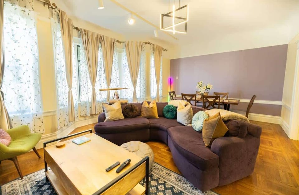 Unwind in a spacious living area filled with natural light and comfy seating.
