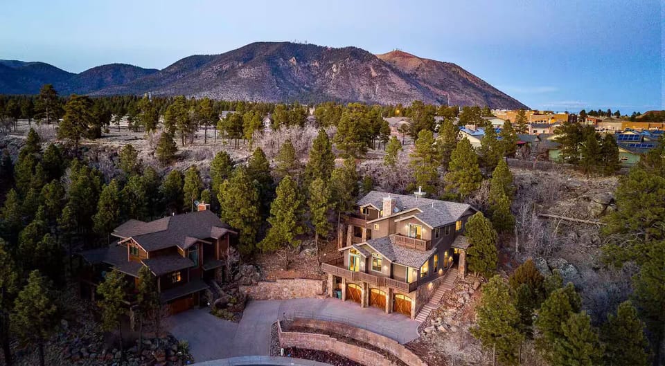 shows home nestled on hillside with Mount Elden closeby