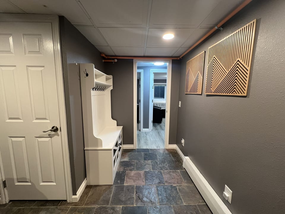 Common Area Downstairs - Bedroom 2 & 3 Doorways with Storage Space and Bench