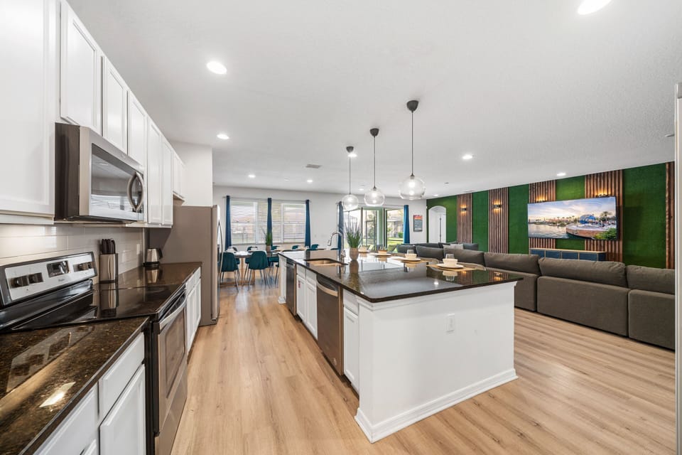 - Spacious kitchen with double islands and full cookware  
- Open design connects seamlessly with dining and lounge  
- Stainless steel appliances and modern finishes throughout