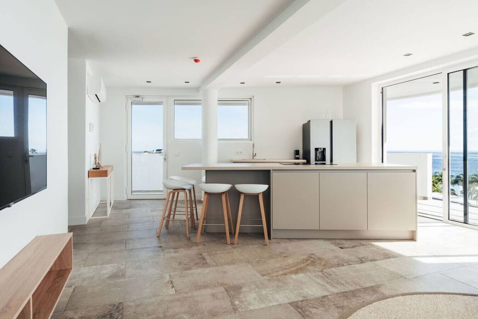 Bright and breezy! This modern kitchen is perfect for cooking up delicious meals while soaking in that gorgeous ocean view. Great vibes all around!