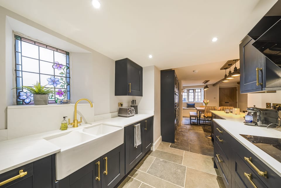 Beech House, Evershot: The kitchen with double sinks and an induction hob