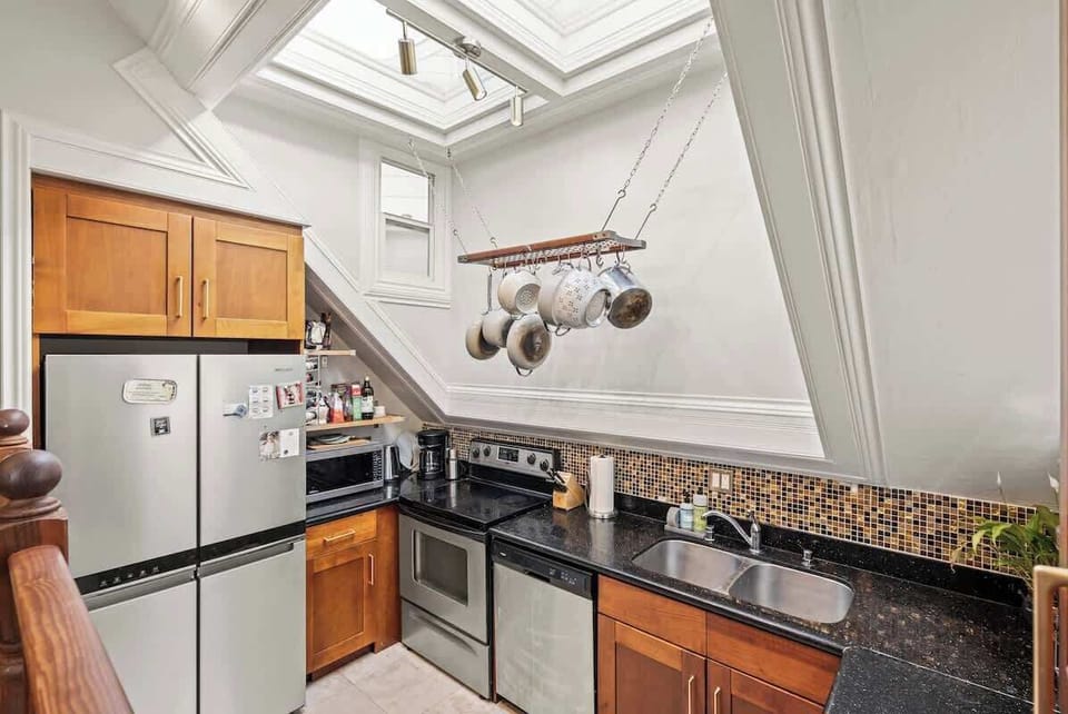 Modern kitchen with skylight and granite counters.