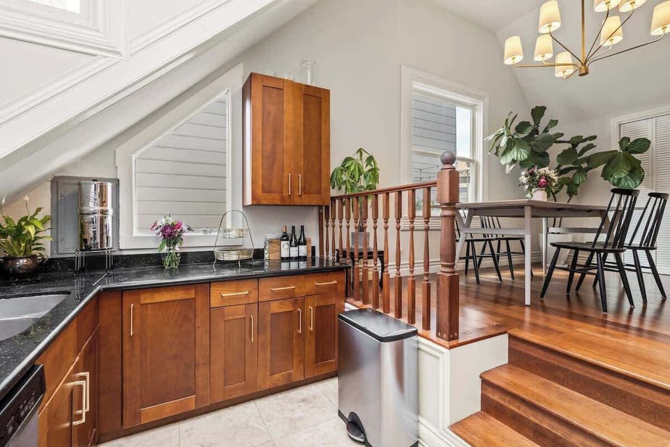 Stairway beside the kitchen with open layout and wooden accents.