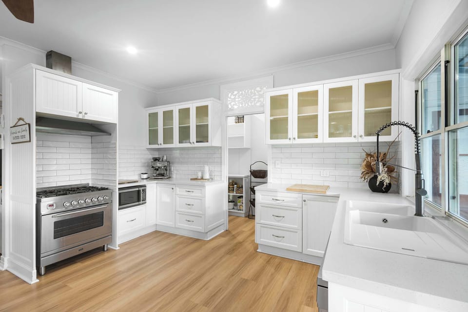 The charming tuckshop style kitchen window opens directly to the alfresco dining space