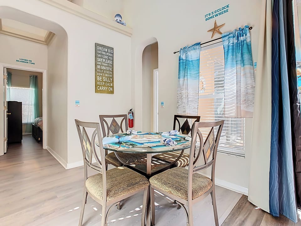 - Coastal themed dining corner with ocean inspired curtains and playful decor
- Wall quotes and beachy accents create a cheerful space for meals and conversation
- Easy access to bedrooms and kitchen makes it perfect for snacks or coffee breaks