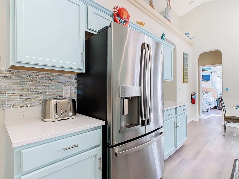 - Full size stainless fridge with filtered water & ice, ready for all your snacks & drinks
- Handy four slice toaster for quick breakfasts before pool time or park adventures
- Sparkling countertops & mosaic backsplash tie together this fun coastal space

