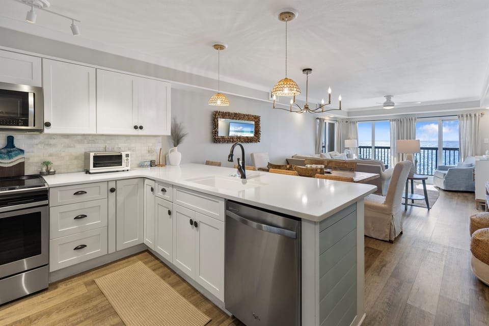 Your open-concept kitchen features gleaming white cabinets, stainless appliances, and a spacious island perfect for morning coffee and meal prep.