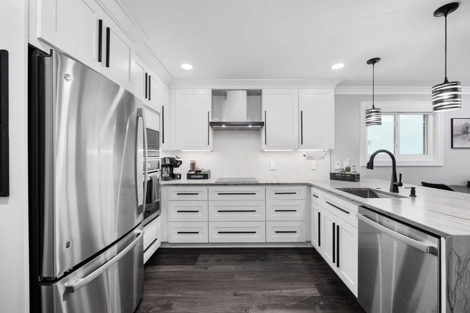 Sleek chef’s kitchen with quartz counters & stainless appliances.