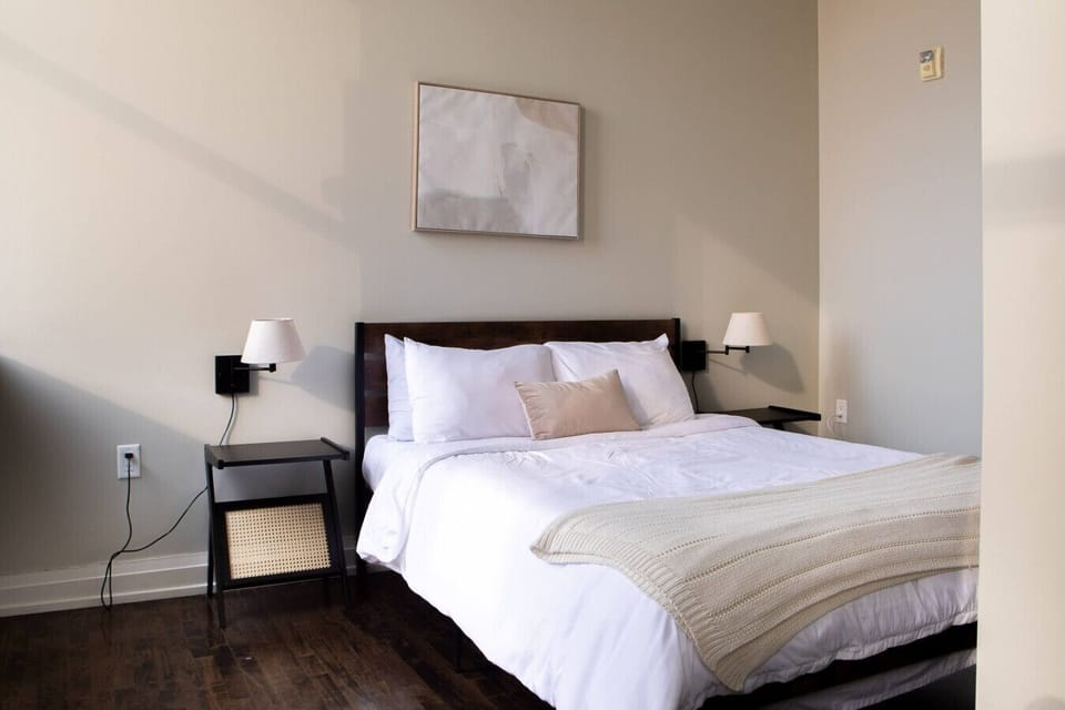 The master bedroom features city views, a premium queen bed, and a luxurious en-suite bathroom