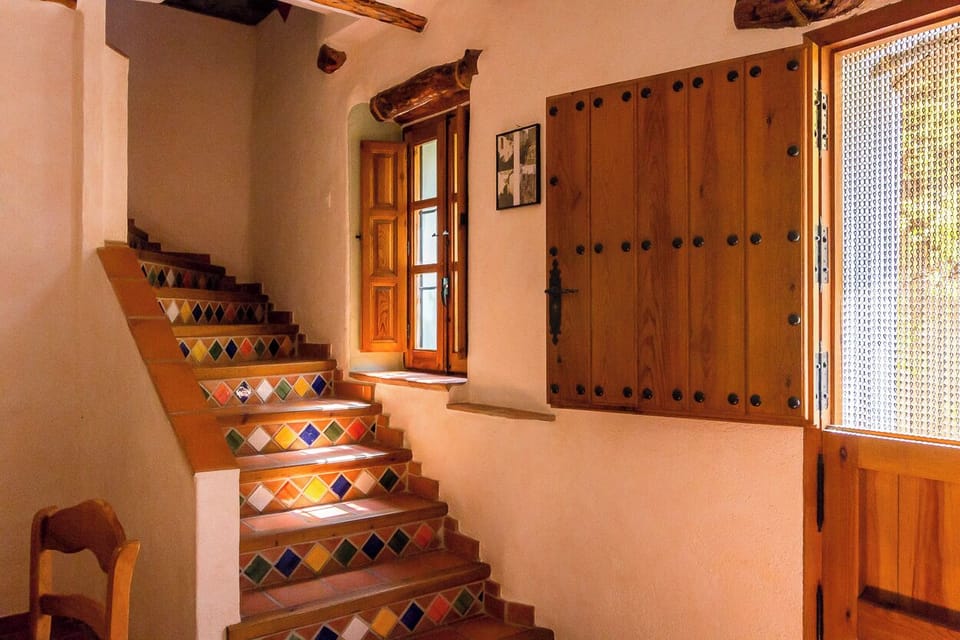 Entrance and staircase with handpainted tiles, leading to livingroom and bedroom