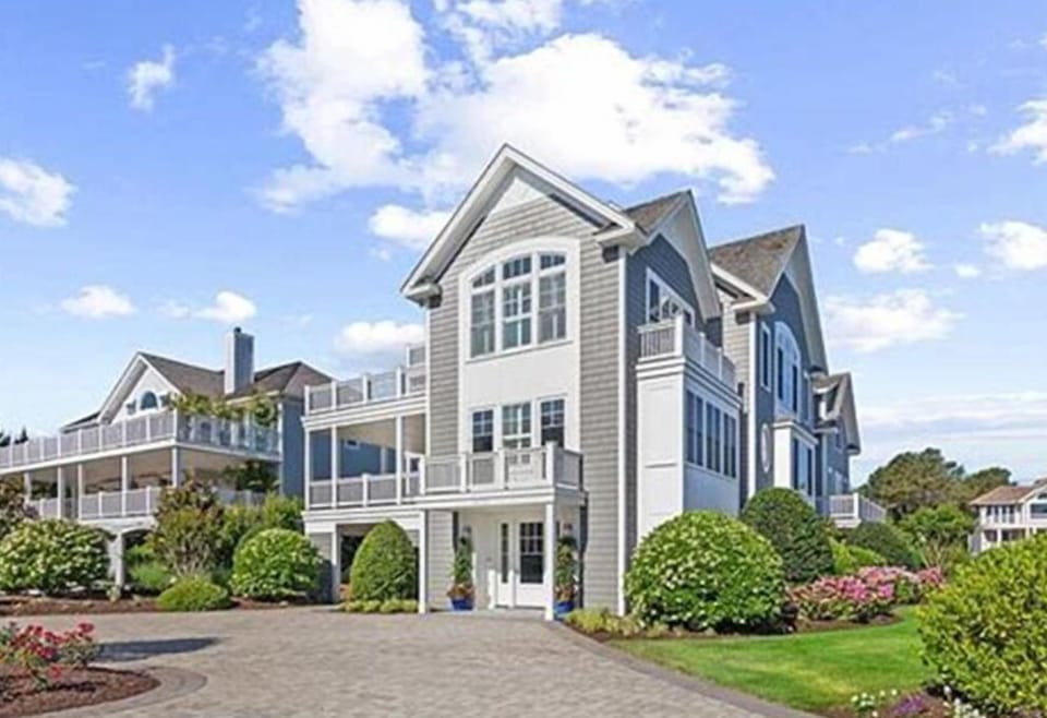 Stunning coastal home just one house from the ocean, featuring elegant architecture and lush landscaping.