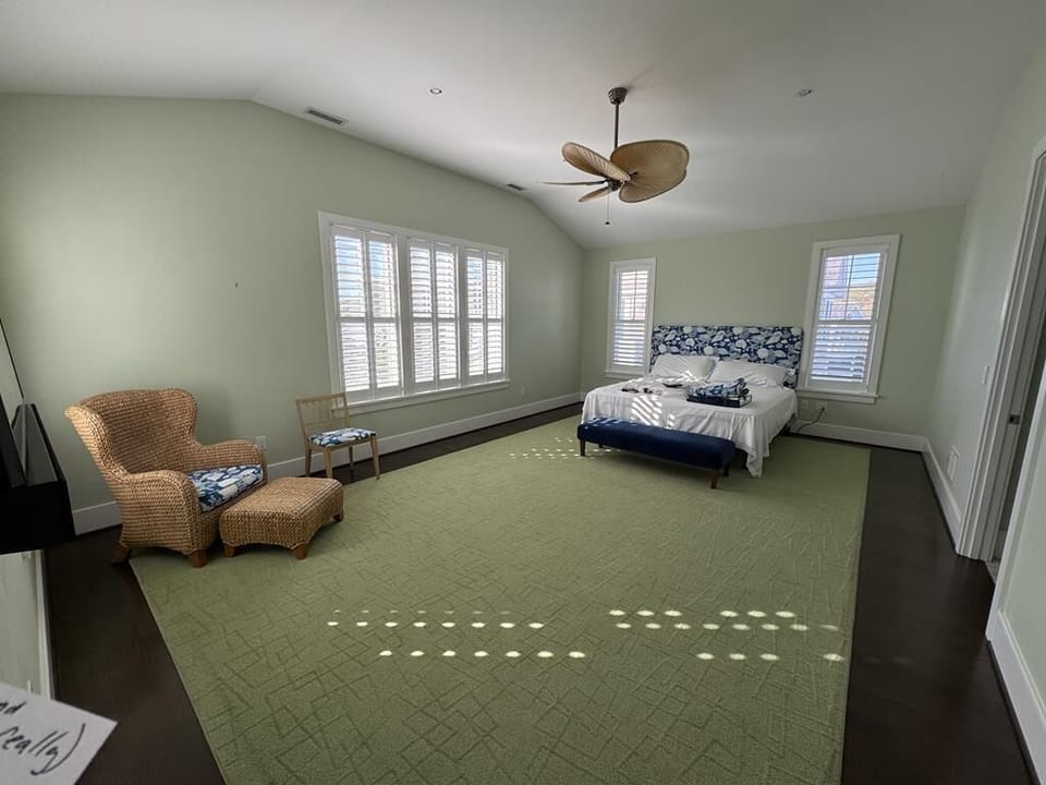 Spacious bedroom with seating area, perfect for relaxation and extra comfort.