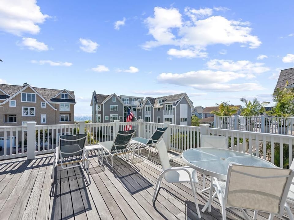 Charming deck space with outdoor seating, offering a peaceful retreat with neighborhood views.