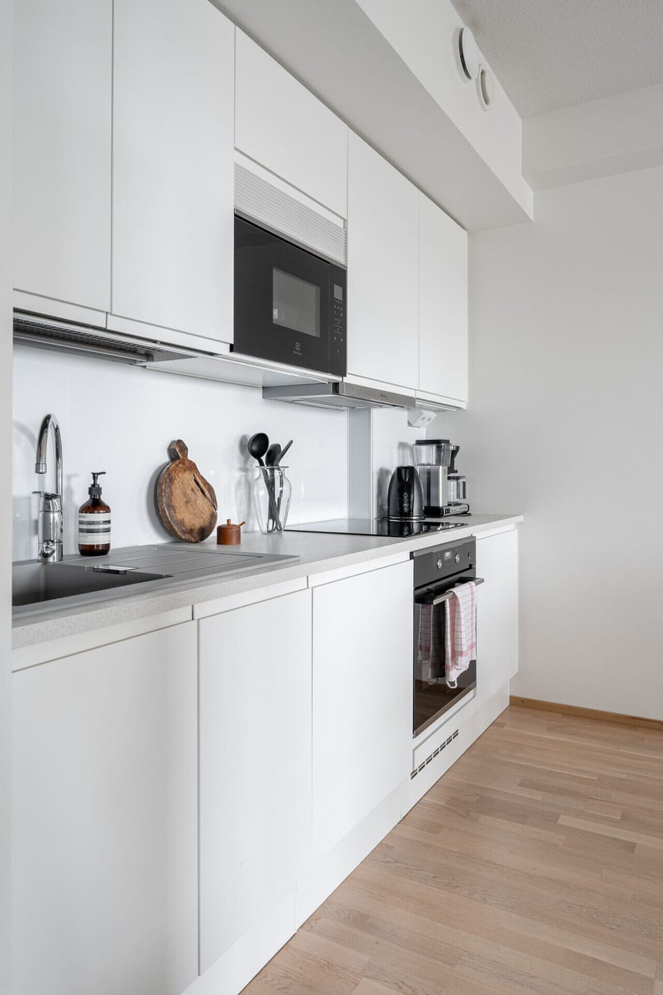 Prepare your favorite meals in a fully equipped kitchen featuring integrated Electrolux appliances and a convenient coffee station.