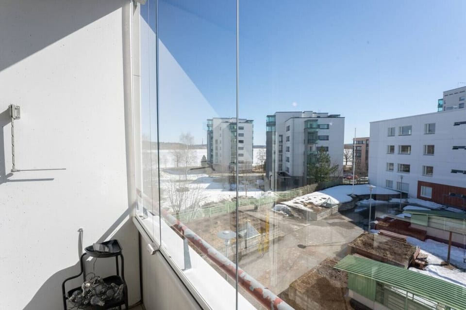 The balcony offers a peaceful view of the modern Lutakko residential area, just a short walk from the lake.