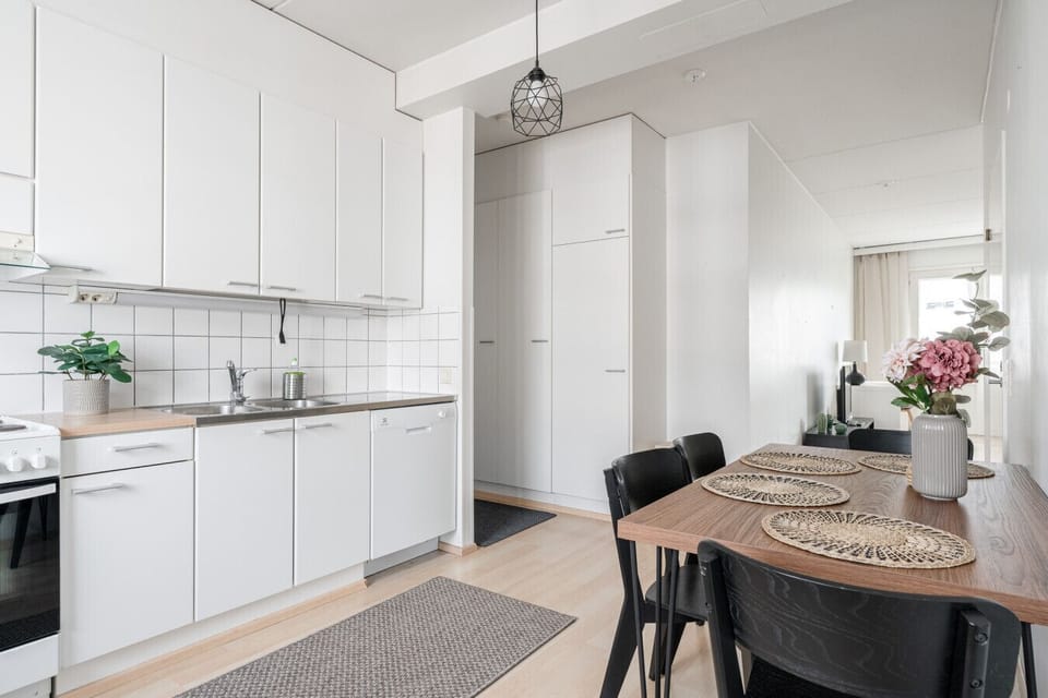 Enjoy home-cooked meals at the full-sized dining table, conveniently located right next to the kitchen for easy serving and socializing.