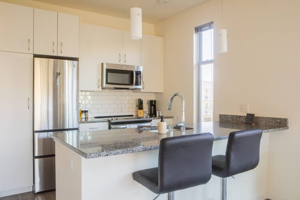 A sun-drenched dining area that doubles as a spacious workstation—perfect for remote work or a morning coffee