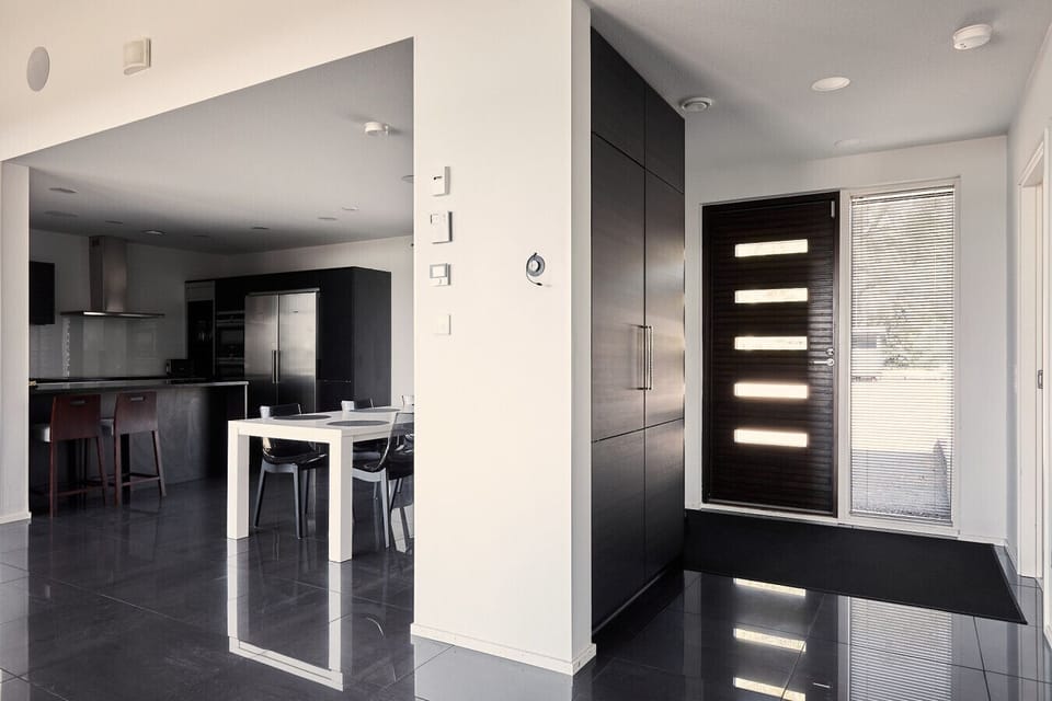 A bright and welcoming entryway that leads directly into the modern, open-plan kitchen and dining space.