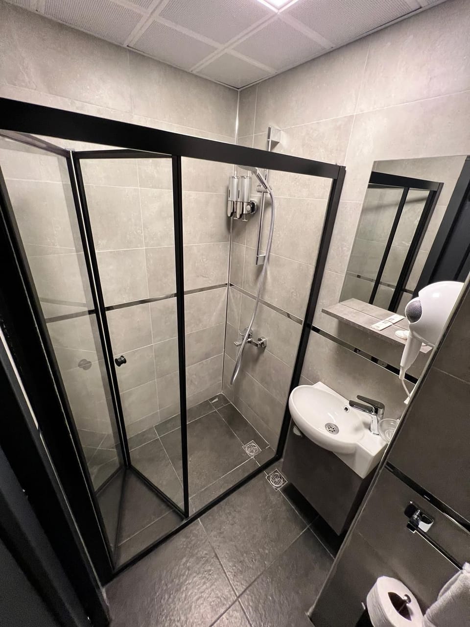 Economy Triple Room, Balcony | Bathroom | Shower, hair dryer, slippers, towels