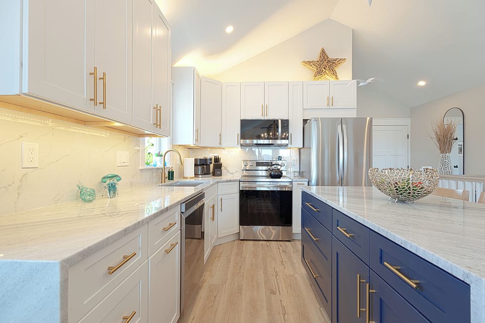 Modern appliances, soft-close cabinetry, granite counters and backsplash. 