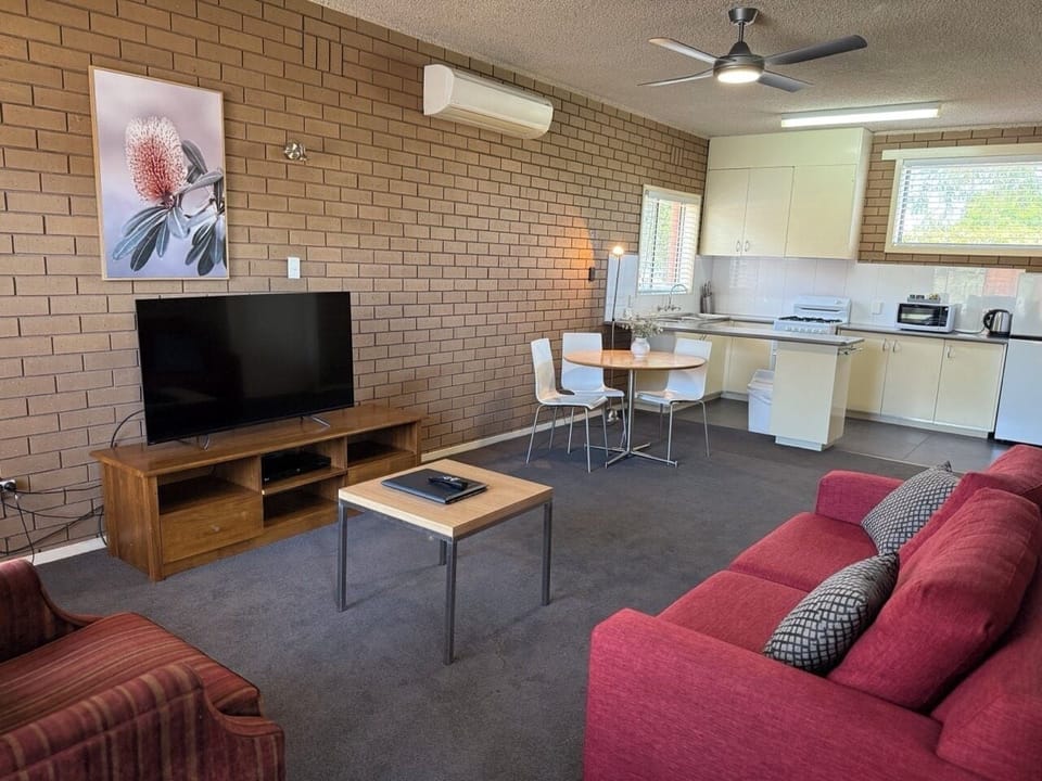 One Bedroom Apartment | Living area | 42-inch flat-screen TV with digital channels, TV, DVD player