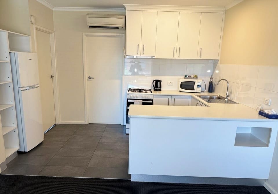Microwave, electric kettle, toaster, cleaning supplies