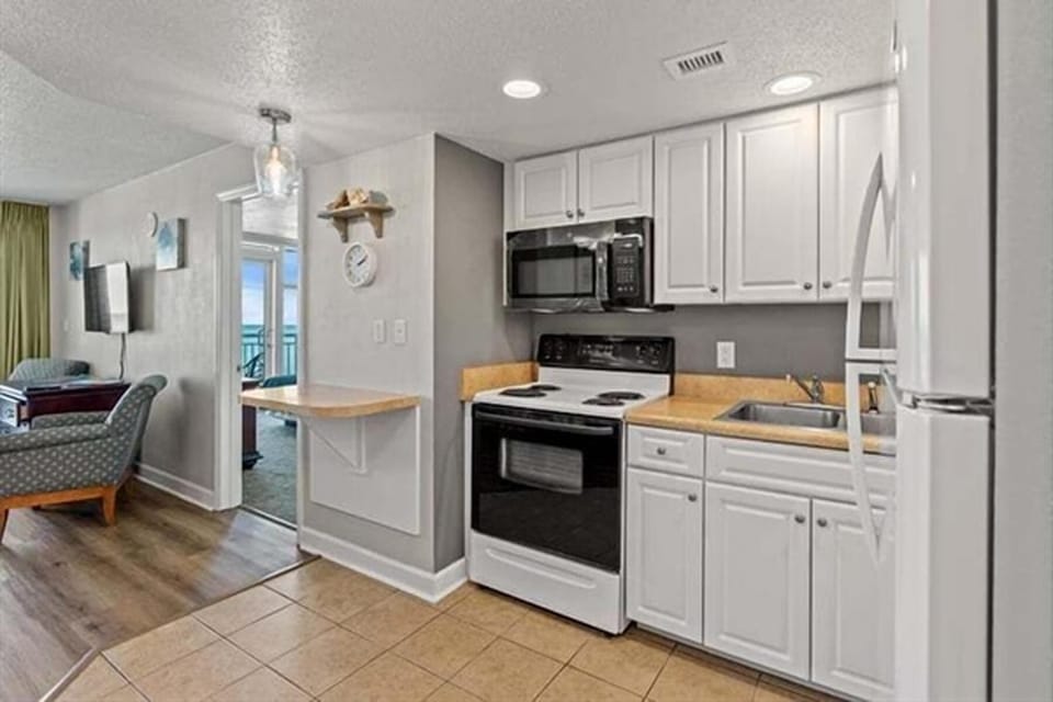 Spacious kitchen with full appliances and modern open layout