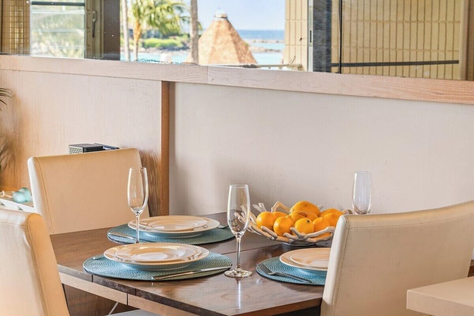 Enjoy meals at this stylish indoor dining table, perfectly positioned to capture natural light and views through the unit's large windows.