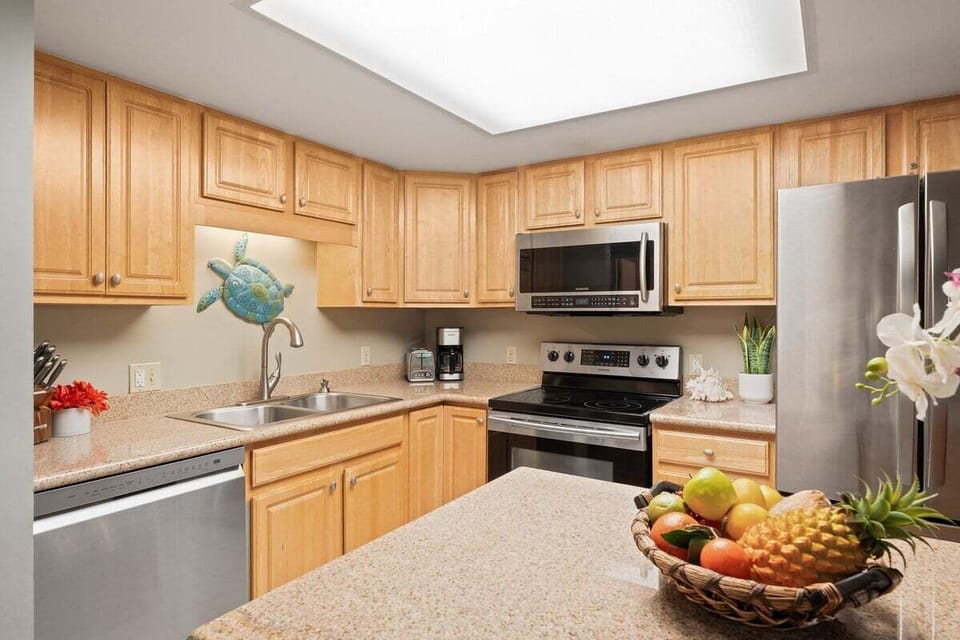 Functional kitchen with stainless steel appliances and white cabinets