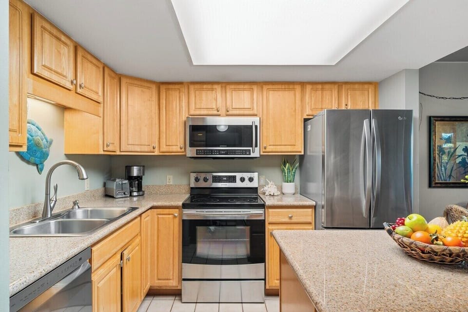 Spacious, and clean kitchen features granite countertop, modern and stainless steel appliances