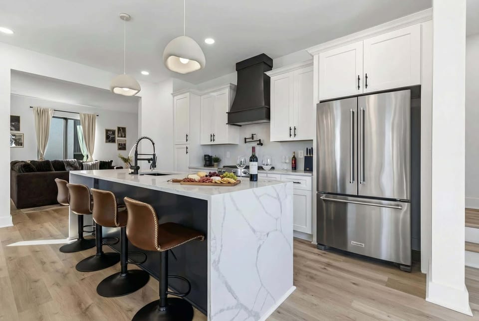 The kitchen island seats four and opens straight to the game room, so the cook stays in the center of the action