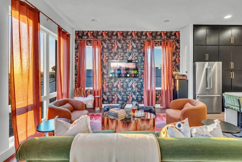 Sink into the green sofa and watch the city from the comfort of the living room. The open-plan layout means you're never left out of the action, even when you want a moment to yourself